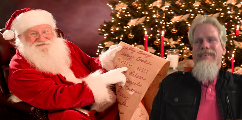 Santa sitting down and pointing to the name Kelly Hill on his list